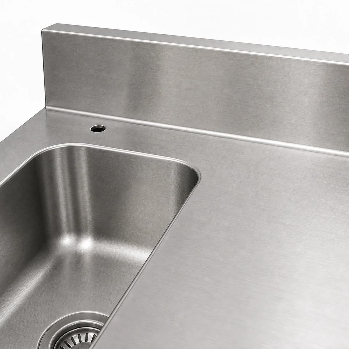 Close-up of the rear backsplash and pre-rinse fitting provision on a dishwasher inlet table