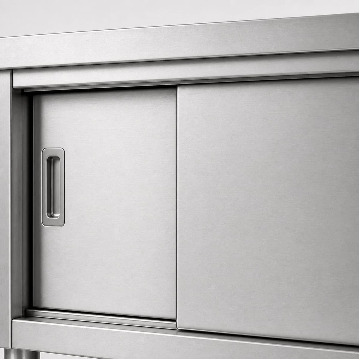 Close-up of the stainless steel sliding door track and overlapping door panels
